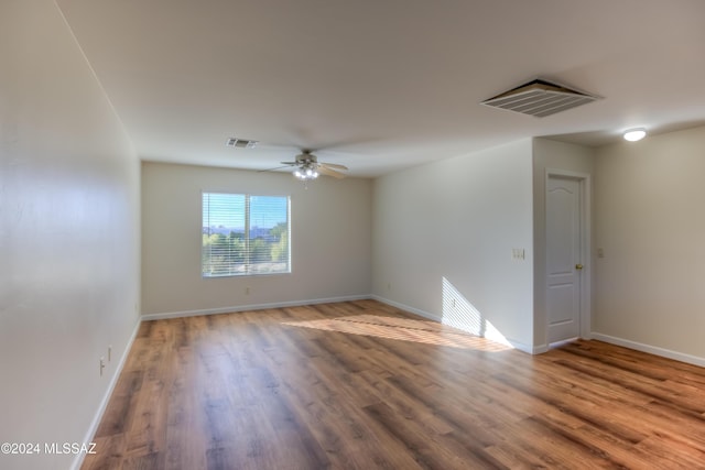 unfurnished room with hardwood / wood-style flooring and ceiling fan