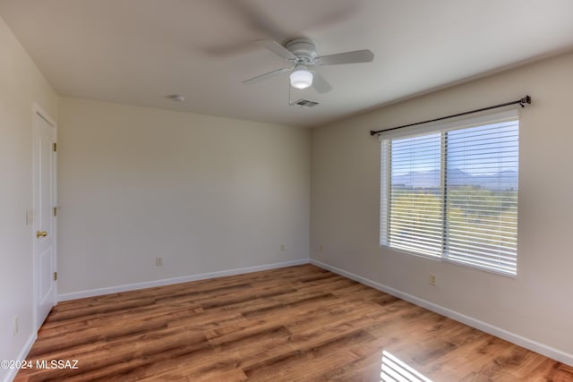 spare room featuring hardwood / wood-style floors and ceiling fan