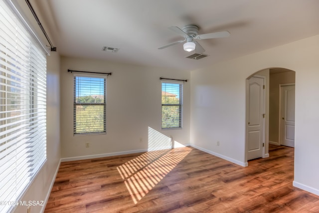 empty room with hardwood / wood-style flooring and ceiling fan