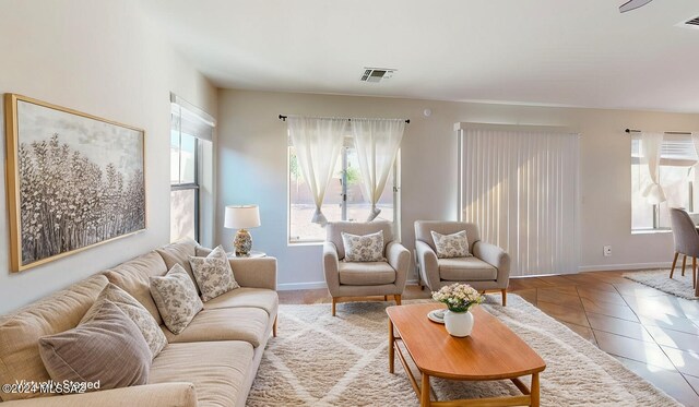 unfurnished living room with ceiling fan and light tile patterned flooring