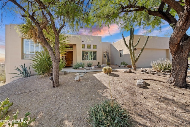 pueblo-style house with a garage