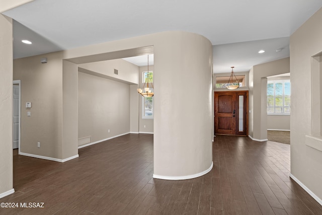 interior space with dark hardwood / wood-style floors and a notable chandelier