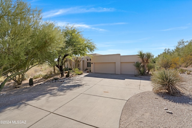 pueblo-style house with a garage