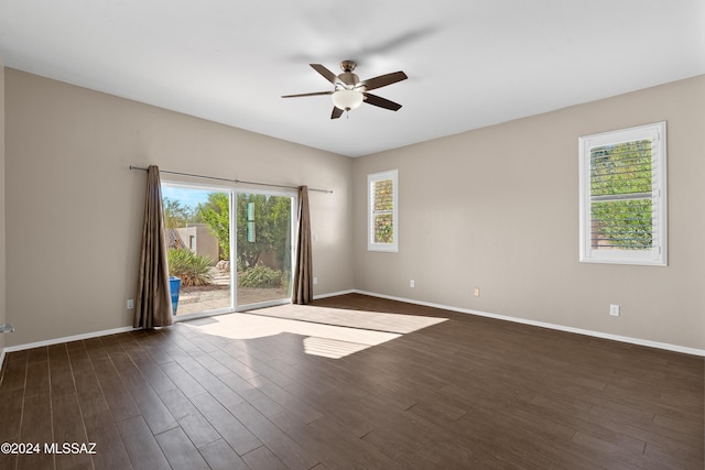 empty room featuring ceiling fan and dark wood-type flooring