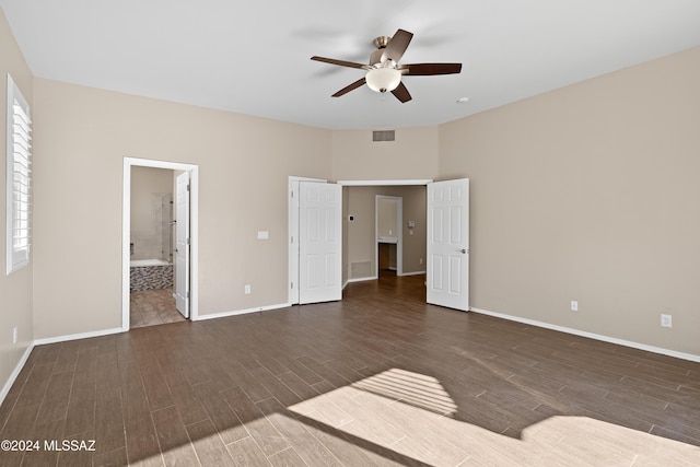 unfurnished bedroom featuring ceiling fan, dark hardwood / wood-style flooring, and ensuite bathroom