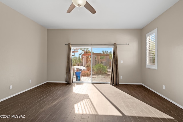 unfurnished room with ceiling fan and dark hardwood / wood-style flooring