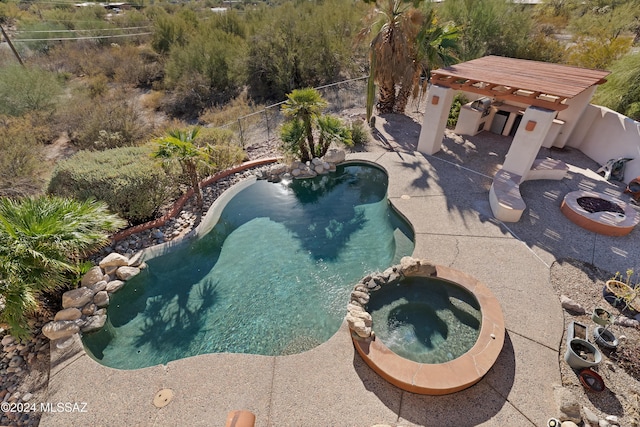 view of pool with a patio area and an in ground hot tub