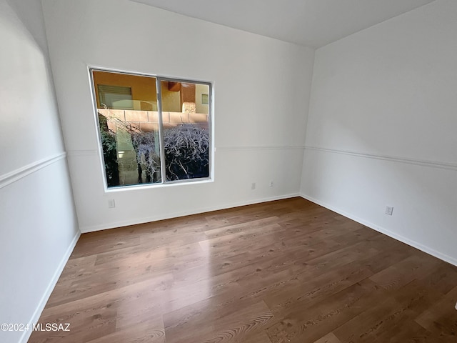 unfurnished room featuring dark wood-type flooring