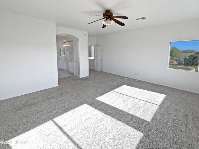 interior space with carpet flooring and ceiling fan