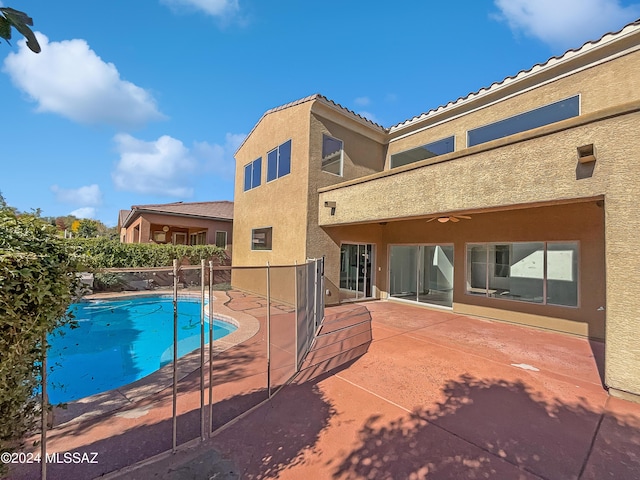 view of swimming pool with ceiling fan and a patio