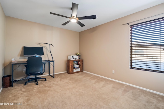 carpeted office featuring ceiling fan