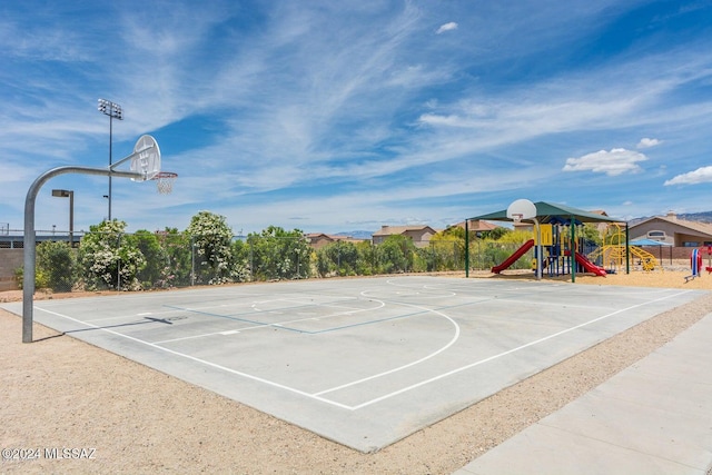 view of sport court with a playground