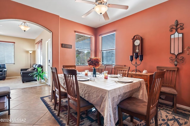 tiled dining space with a wealth of natural light and ceiling fan