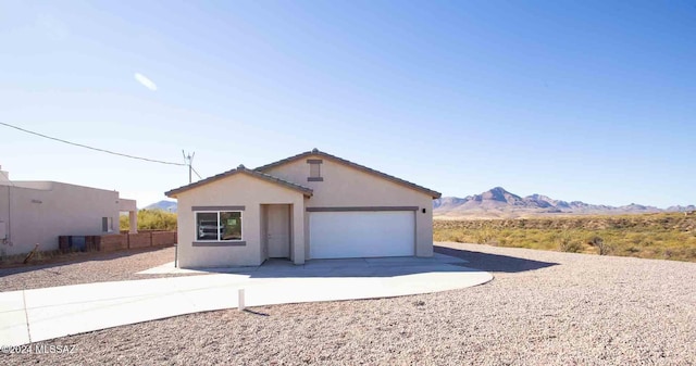 view of front of house with a mountain view and a garage