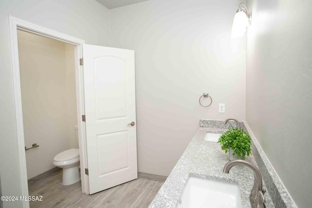 bathroom featuring hardwood / wood-style floors, vanity, and toilet