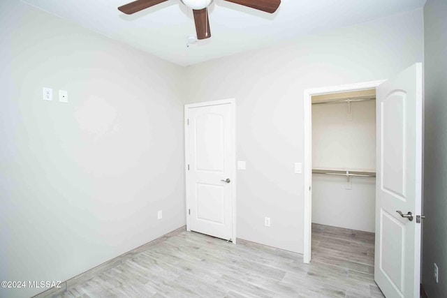 unfurnished bedroom featuring light wood-type flooring, a closet, and ceiling fan