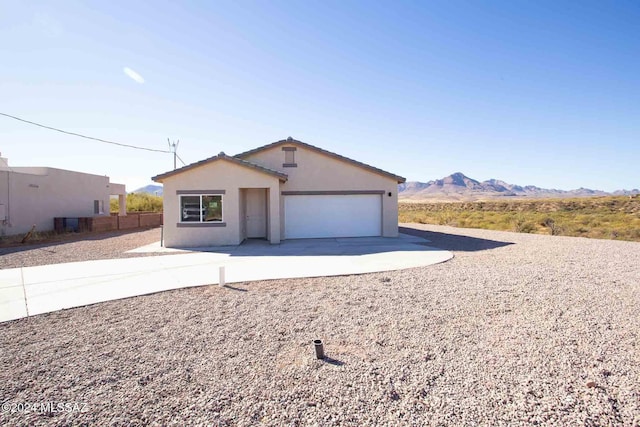 view of front facade featuring a mountain view and a garage