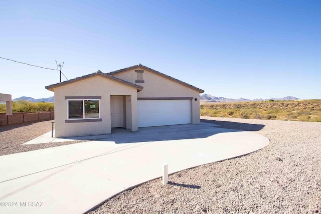 view of front of property featuring a mountain view and a garage