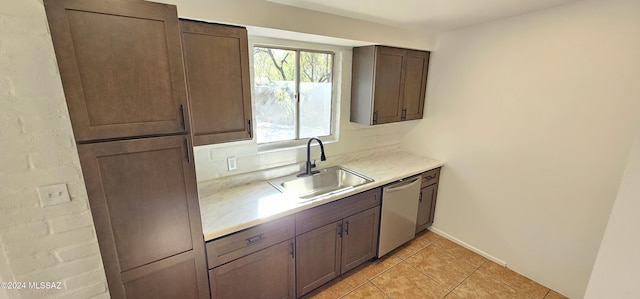 kitchen with stainless steel dishwasher, dark brown cabinets, light tile patterned floors, and sink