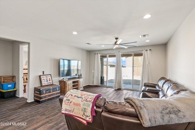 living room featuring ceiling fan and dark wood-type flooring