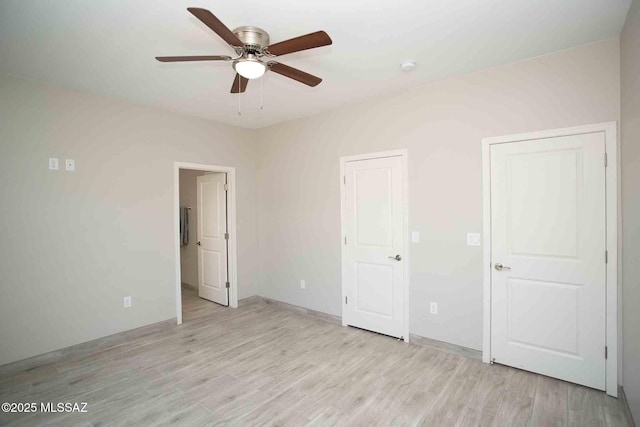 unfurnished bedroom featuring ceiling fan and light wood-type flooring