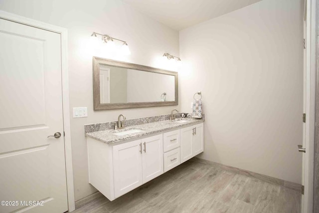 bathroom with vanity and hardwood / wood-style floors