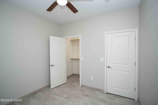 unfurnished bedroom with light hardwood / wood-style floors and ceiling fan