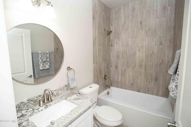 full bathroom featuring vanity, tiled shower / bath combo, and toilet