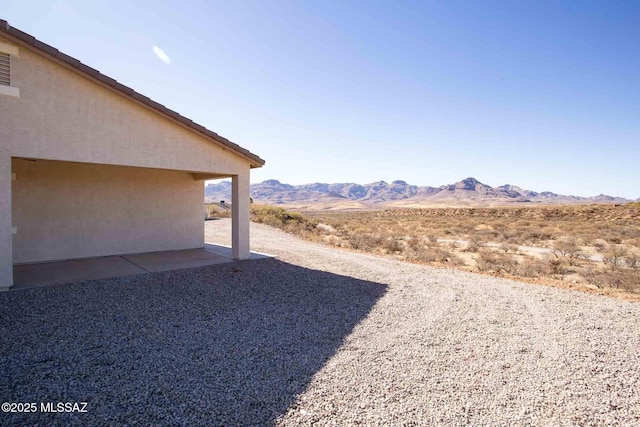 view of yard featuring a mountain view and a patio