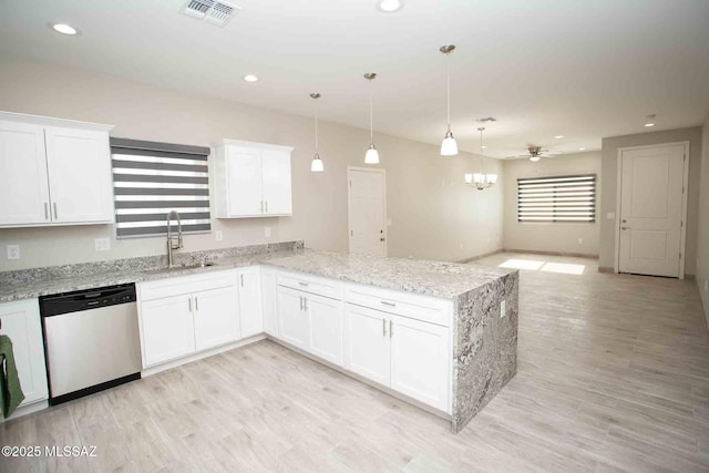 kitchen featuring sink, white cabinetry, decorative light fixtures, stainless steel dishwasher, and light wood-type flooring