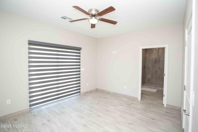 empty room featuring ceiling fan and light wood-type flooring