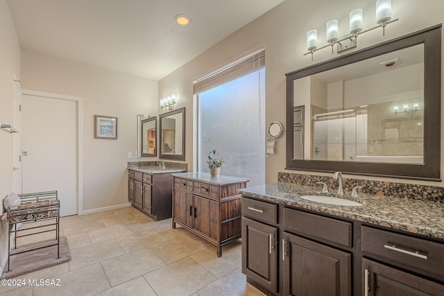 bathroom with two vanities, a sink, tile patterned flooring, and a shower stall