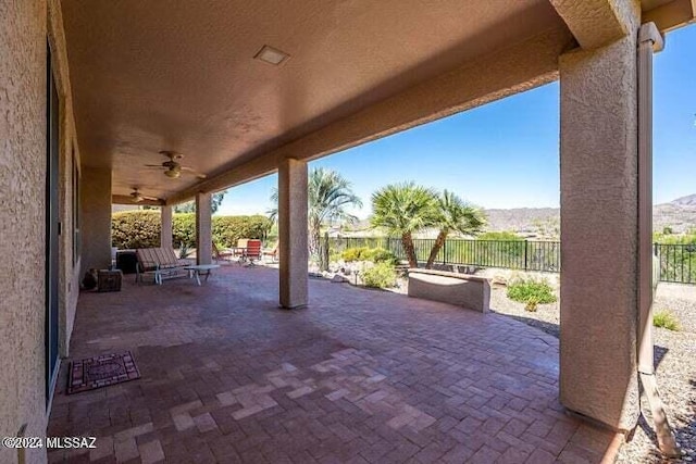 view of patio with a fenced backyard and a ceiling fan