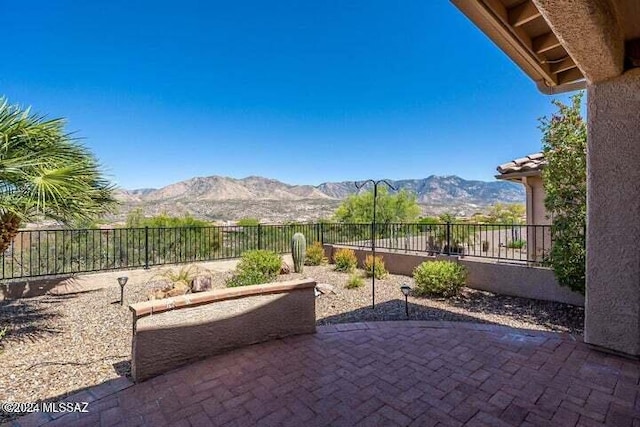 view of patio / terrace with a fenced backyard and a mountain view
