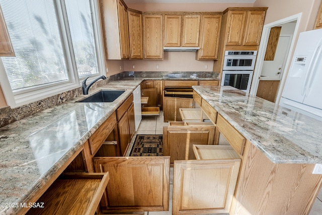 kitchen with a kitchen island, black electric stovetop, under cabinet range hood, double oven, and a sink