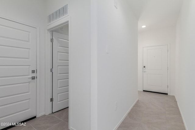 hall featuring light tile patterned floors