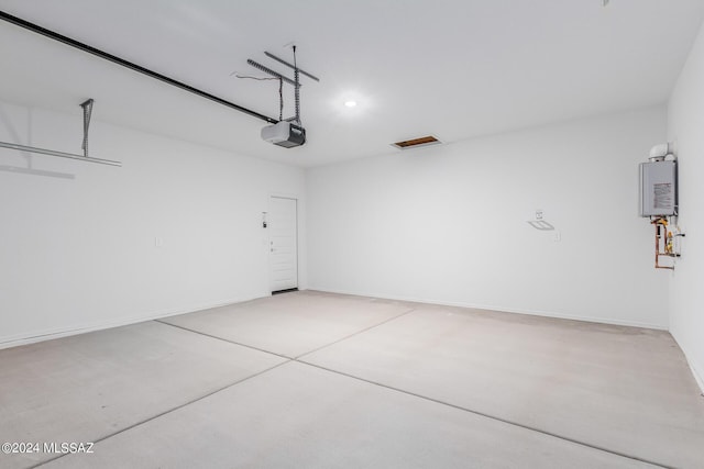 garage featuring a garage door opener and water heater