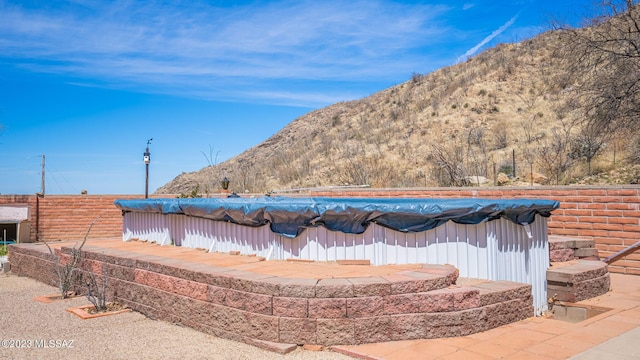 exterior space featuring a mountain view and a swimming pool