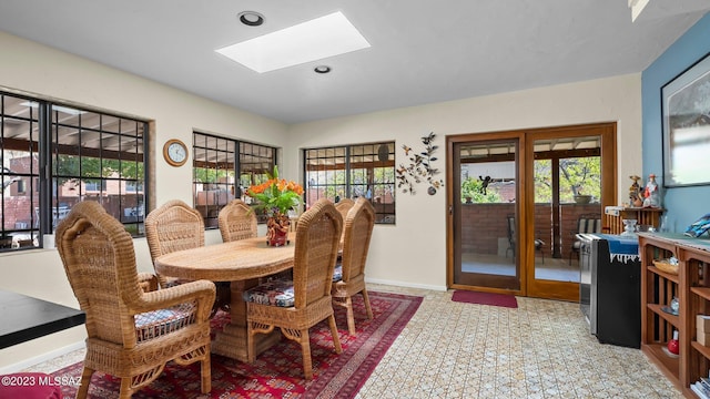 dining room featuring french doors and a skylight