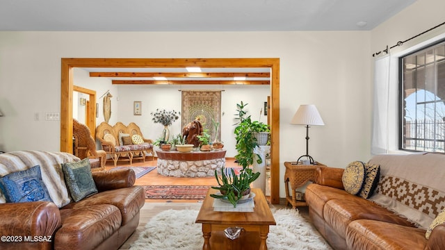 living room with beam ceiling and light hardwood / wood-style floors