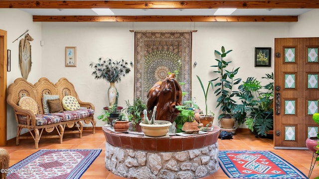 interior space with tile patterned floors and beamed ceiling