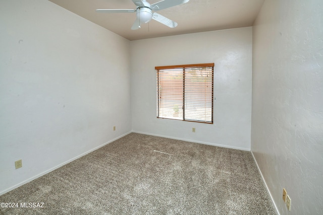 unfurnished room featuring ceiling fan and carpet