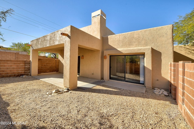 back of property with a patio