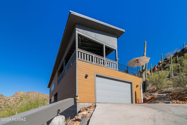 view of front of property with a balcony and a garage