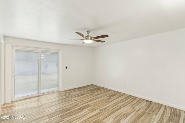 empty room with ceiling fan and light hardwood / wood-style floors