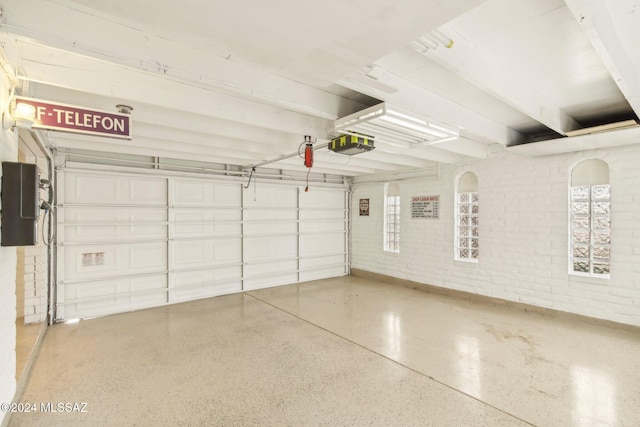 garage with electric panel and a garage door opener