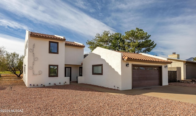 mediterranean / spanish house featuring a garage