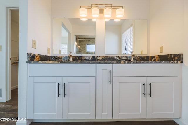 bathroom with a shower, wood-type flooring, and vanity