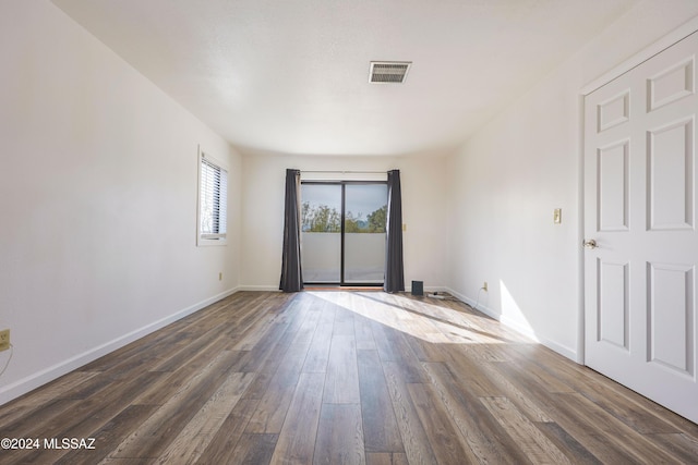 spare room featuring dark hardwood / wood-style flooring