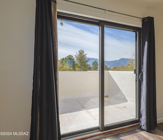 doorway to outside with a mountain view and wood-type flooring